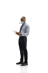 Image showing Young african-american call center consultant with headset isolated on white studio background