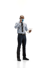 Image showing Young african-american call center consultant with headset isolated on white studio background