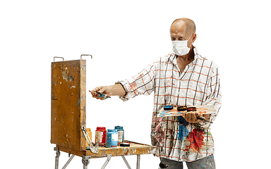 Image showing Artist, painter at work isolated on white studio background