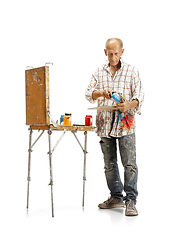Image showing Artist, painter at work isolated on white studio background