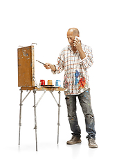 Image showing Artist, painter at work isolated on white studio background