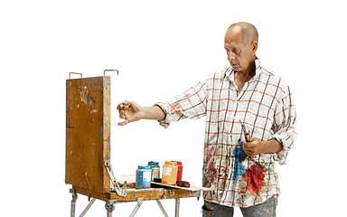 Image showing Artist, painter at work isolated on white studio background