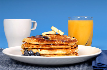 Image showing Blueberry pancakes with coffee and orange juice