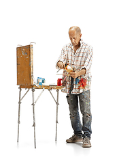 Image showing Artist, painter at work isolated on white studio background