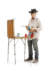 Image showing Artist, painter at work isolated on white studio background