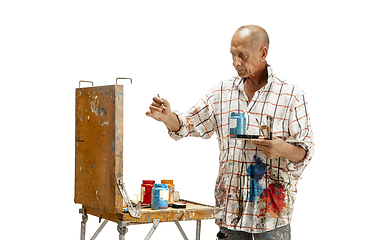 Image showing Artist, painter at work isolated on white studio background