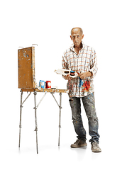 Image showing Artist, painter at work isolated on white studio background