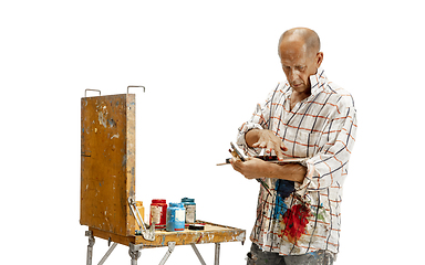 Image showing Artist, painter at work isolated on white studio background