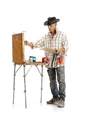 Image showing Artist, painter at work isolated on white studio background