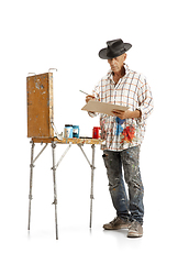 Image showing Artist, painter at work isolated on white studio background