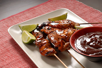 Image showing Grilled chicken satay, limes and sauce