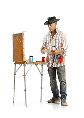 Image showing Artist, painter at work isolated on white studio background