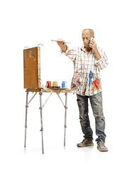 Image showing Artist, painter at work isolated on white studio background