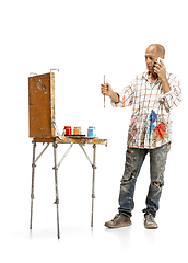 Image showing Artist, painter at work isolated on white studio background