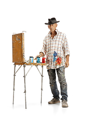 Image showing Artist, painter at work isolated on white studio background