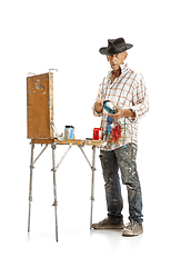 Image showing Artist, painter at work isolated on white studio background