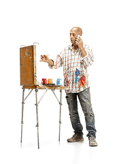 Image showing Artist, painter at work isolated on white studio background