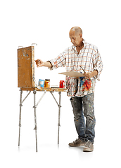 Image showing Artist, painter at work isolated on white studio background