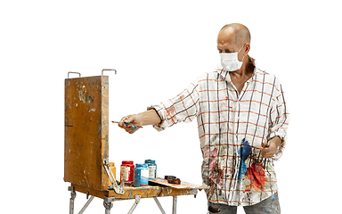 Image showing Artist, painter at work isolated on white studio background