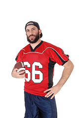 Image showing Young football player standing in closeup with his football 