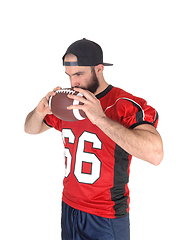 Image showing Football player holding his ball on his mouth thinking