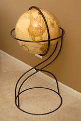 Image showing Antique world globe on iron stand