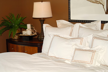 Image showing Bed with white bedspread and nightstand