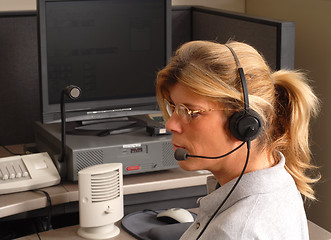 Image showing Police dispatcher sitting at a dispatch console