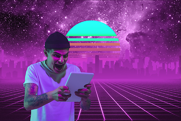 Image showing Synth wave and retro wave, vaporwave futuristic aesthetics. Man with device in glowing neon style.