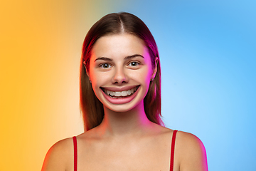 Image showing Smiling girl with surreal huge smile and big mouth looks shocked, attracted, wondered and astonished. Copyspace for ad.