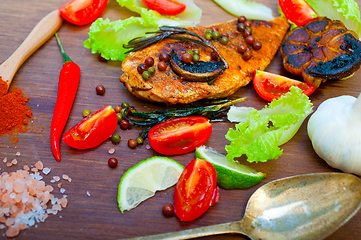 Image showing wood fired hoven cooked chicken breast on wood board