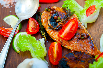 Image showing wood fired hoven cooked chicken breast on wood board