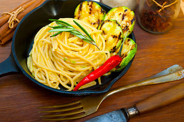 Image showing italian spaghetti pasta with zucchini sauce on iron skillet