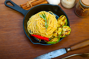 Image showing italian spaghetti pasta with zucchini sauce on iron skillet