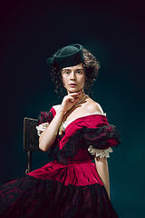 Image showing Young woman as Anna Karenina on dark blue background. Retro style, comparison of eras concept.