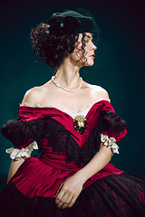 Image showing Young woman as Anna Karenina on dark blue background. Retro style, comparison of eras concept.