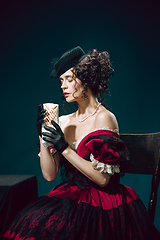 Image showing Young woman as Anna Karenina on dark blue background. Retro style, comparison of eras concept.