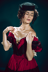 Image showing Young woman as Anna Karenina on dark blue background. Retro style, comparison of eras concept.