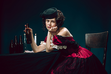 Image showing Young woman as Anna Karenina on dark blue background. Retro style, comparison of eras concept.