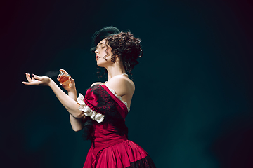 Image showing Young woman as Anna Karenina on dark blue background. Retro style, comparison of eras concept.