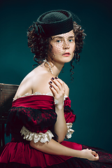 Image showing Young woman as Anna Karenina on dark blue background. Retro style, comparison of eras concept.