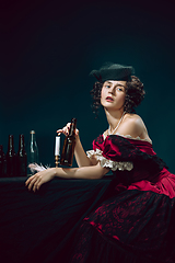 Image showing Young woman as Anna Karenina on dark blue background. Retro style, comparison of eras concept.