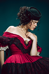 Image showing Young woman as Anna Karenina on dark blue background. Retro style, comparison of eras concept.