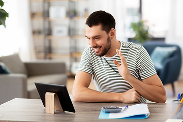 Image showing man with tablet pc having video call at home