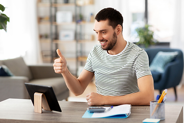 Image showing man with tablet pc having video call at home