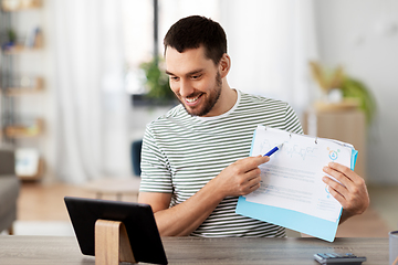 Image showing man with tablet pc having video call at home