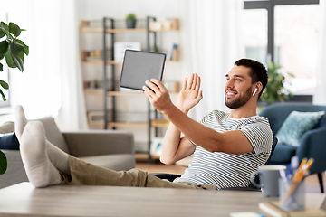 Image showing man with tablet pc having video call at home