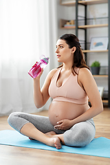 Image showing pregnant woman drinking water after yoga at home