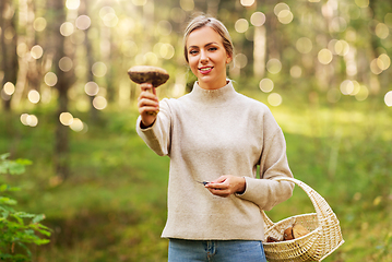 Image showing young woman with mushroom in autumn forest