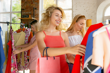 Image showing Wear, clothing shop during sales, summer or autumn collection. Young women looking for new attire